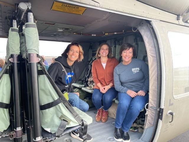 Teachers Shannon Altom, Jodee Haack, and Lori Heard go for a ride in a Black Hawk helicopter courtesy of the National Guard.
